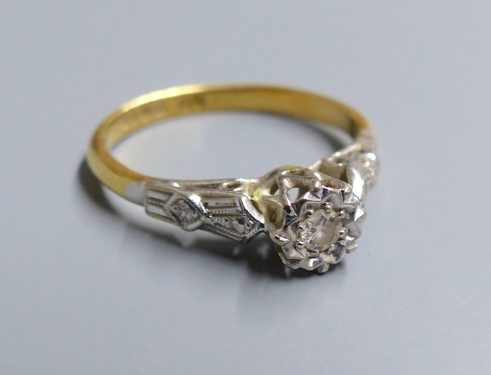 A 1960s 18ct gold and illusion set solitaire diamond ring, size J/K, gross 2.4 grams.